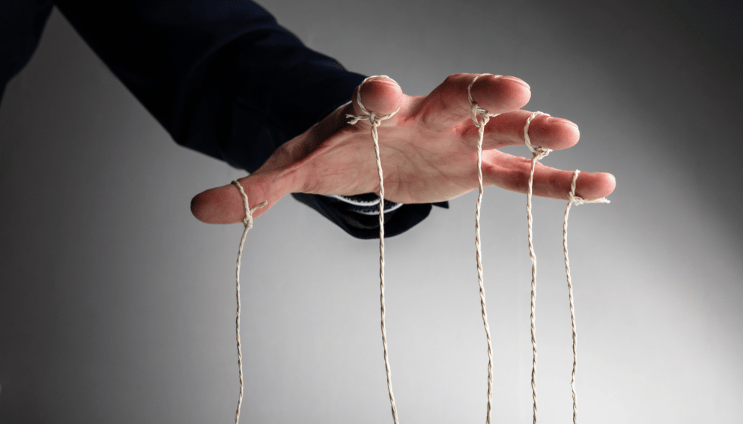 picture of a hovering hand with puppet strings descending from each fingers