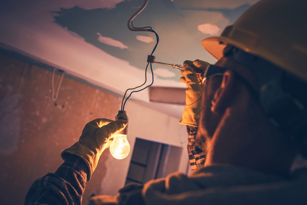 Electrician fixing a light bulb